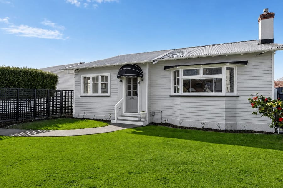 The same Wellington bungalow after repainting, with a clean, even white finish