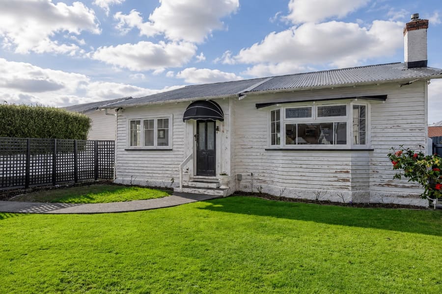 Wellington weatherboard bungalow before repainting, with peeling and patchy paintwork