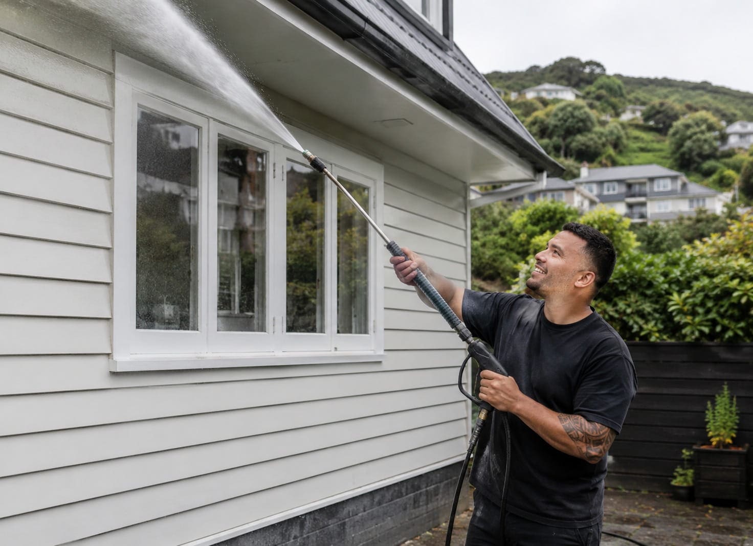 Water blasting the exterior cladding of a Wellington house